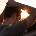 A man with his arms on his head.