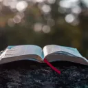 An open Bible laying on a table.