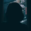 A woman looking out a window.