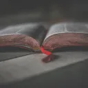 An open Bible laying on a table.