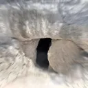 A tomb with round stone in the doorway.