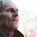 An older man looking ahead.