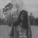 A woman walking in a field.
