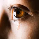 A tear dripping from a person's eye.