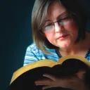 A woman reading a Bible.