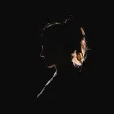 A silhouette of a young woman.