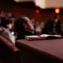 A man sitting in an audience.