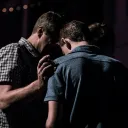Two men praying together.