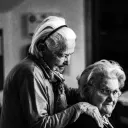 Two elderly women beside each other.