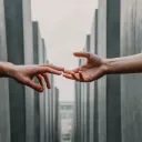 One person reaching out to touch the hand of another person.