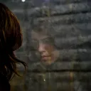 The reflection of a woman in a window.