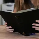 A woman reading a Bible.
