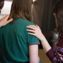 A small group of women praying together.