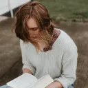 A woman reading a Bible.