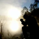 Silhouette of a man praying.