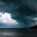 Photo of storm clouds over the ocean.