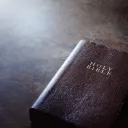 A Bible laying on a table.