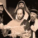 A photo illustration of the apostles and one of them is reading from a scroll.