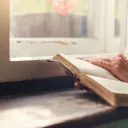A woman reading a Bible.
