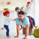 A dad playing with his kids.