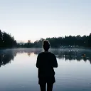 A woman looking at a lake.