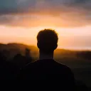 A young man watching the sunset.