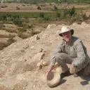 The author examines a stone grinder and bowl at Tall el-Hammam before excavations began.