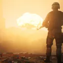 A soldier looking at a huge blast in the sky.