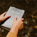 A person holding a Bible.