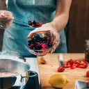 a person canning fruit in the kitchen