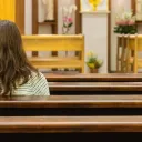 A woman sitting in a church.
