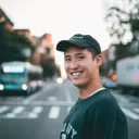a smiling man with a city street background