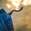 A person blowing a shofar.