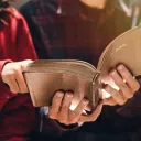 Two people looking at an open Bible.