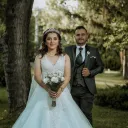 a bride and a groom walking outside