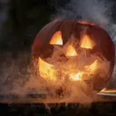 a jack-o-lantern that is glowing with smoke coming out from inside