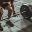 a man squatting to pick up a heavy weight