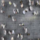 People walking on a big sidewalk.