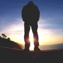 A person standing with the sun's rays shining.