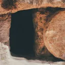 Upclose of a tomb with a round stone.