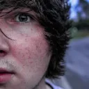 Upclose photo of a young man's face.