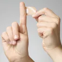 A Band-Aid being wrapped around a finger.