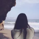 A woman looking at the ocean.