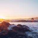 Sunset over a rocky beach.