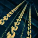 Old chains hanging down from a dark ceiling.
