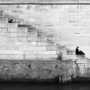 A person sitting on old stairs.