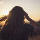 A young woman with her hair blowing in the wind.