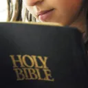 A woman reading a Bible.