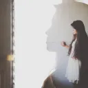 The silhouette of a young woman.