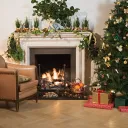 A Christmas tree in a festively decorated living room.